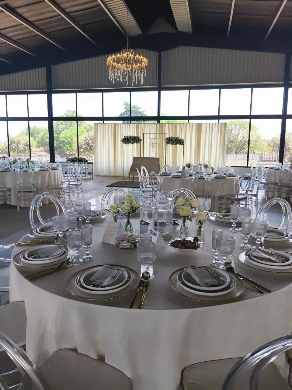 Main hall with round tables beneath chandeliers